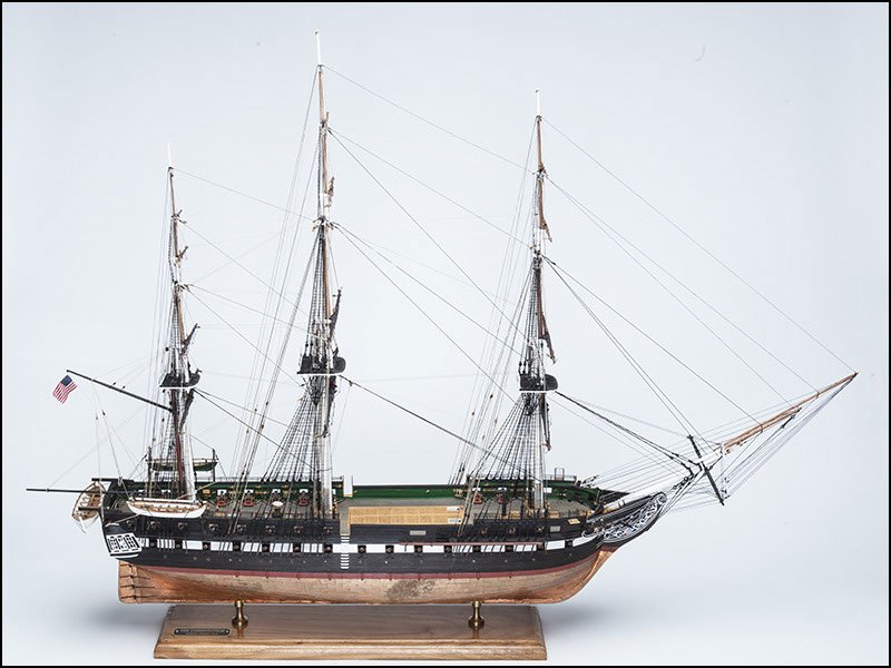 Full side view of the scratch-built USS Constitution model under full rigging, on a white background