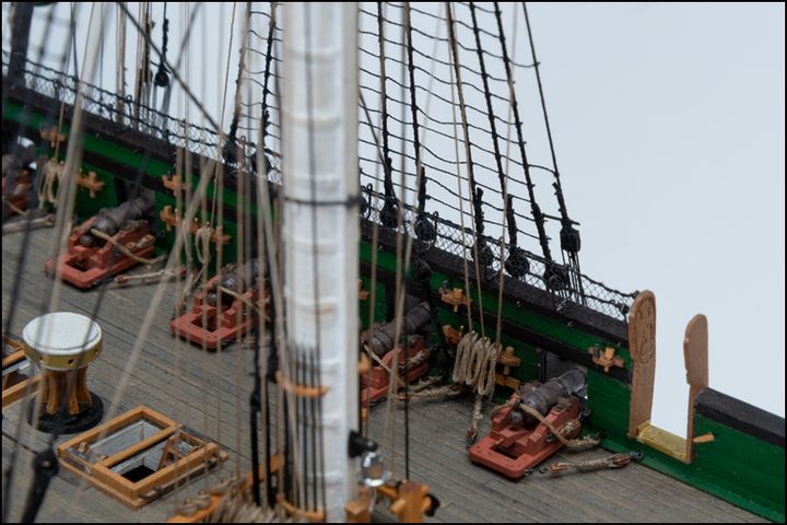 Close-up of the deck with blackened silver cannons on cherry carriages