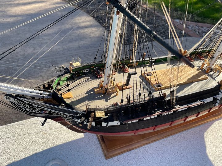 The bow, bowsprit, and forward spar deck seen from above in sunlight