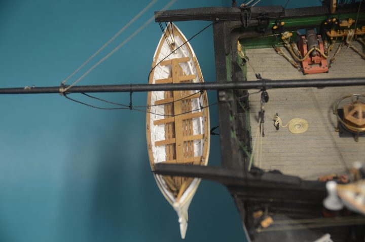 A ship's boat hanging from the stern davits, seen from above