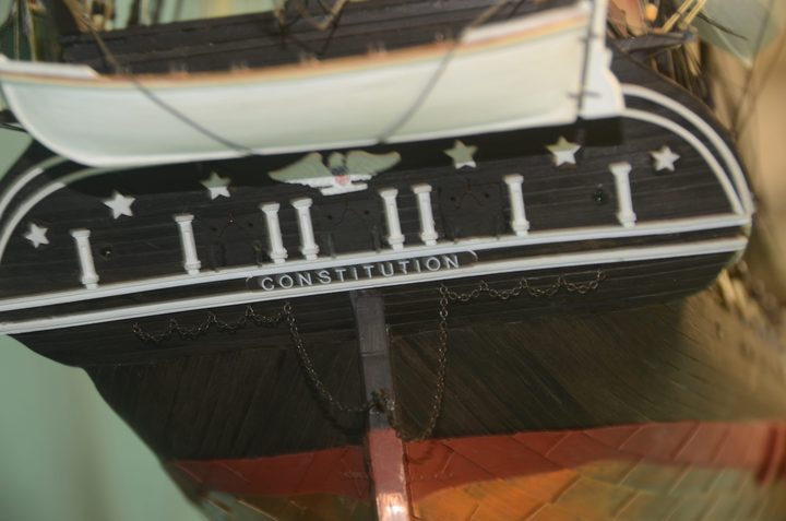 The stern, with the name CONSTITUTION, an eagle, and stars