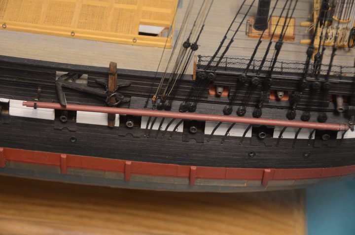 An anchor, a spare spar, and the fore channels on the side of the hull
