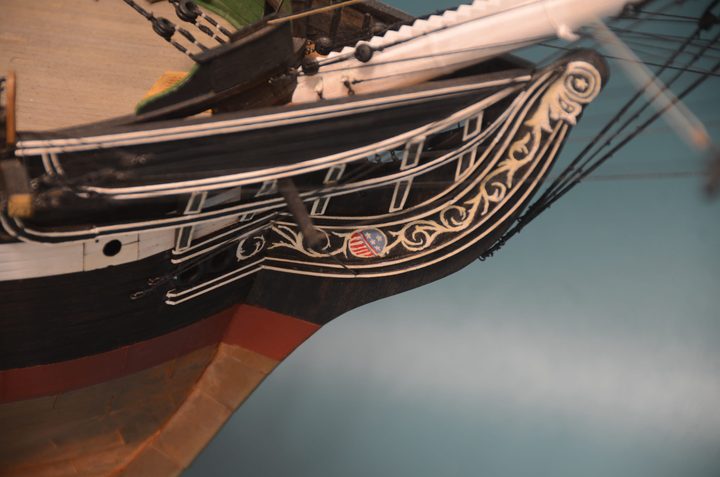 Hand-painted scrollwork on the bow, with a shield