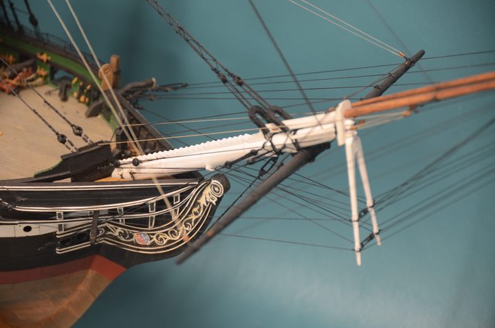 The bow, with its hand-painted scrollwork, the bowsprit, and the dolphin striker
